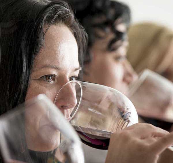 Close-up of a guest sipping red wine during a Hunter Valley wine tasting